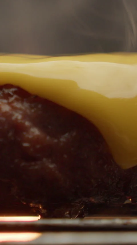 Burger patty with dripping cheese vertical video macro 스톡 동영상 310958071
