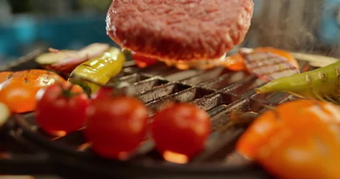 Burger patty dropping around vegetables Stock Footage 311829910