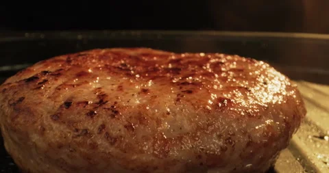 Burger patty preparing on a grill in fire. Hamburger or cheeseburger preparation Stock Footage 296088431