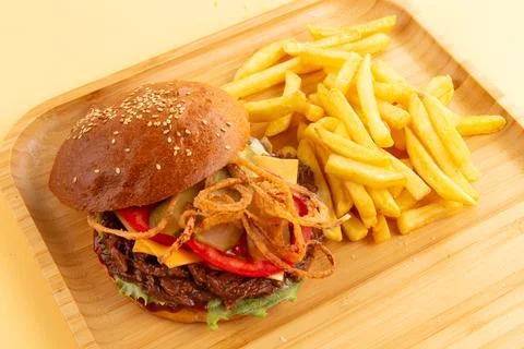 Burger with pulled beef, onion rings and fries. Stock Photos