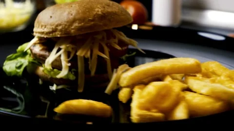Burger Rotating on a Plate Display Against cafe Background. food and drink, Vídeo Stock 336579141