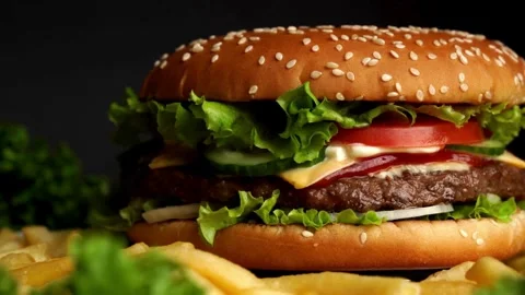 Burger Rotating on a Plate Display Against Black Background. food and drink, Video stock 336579219