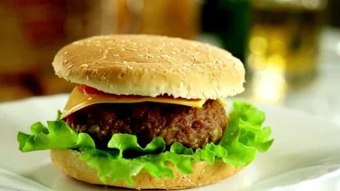 Burger Rotating on a Plate Display Against cafe Background. food and drink, Video stock 336579374