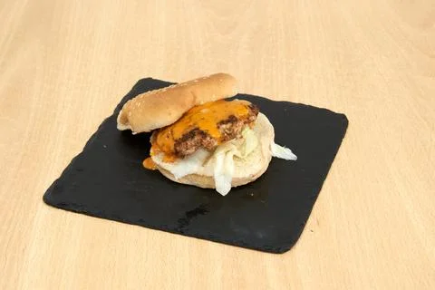 A burger with a slice of cheese on top of it Stock Photos