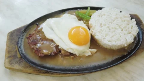 Burger Steak with egg served on a hot plate. Video stock 147051980
