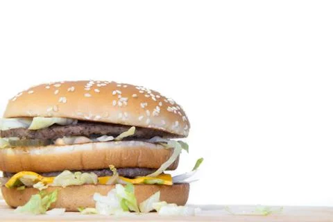 Burger on a white background. Cutlets bun sesame, cheese salad dressing. Impr Stock Photos