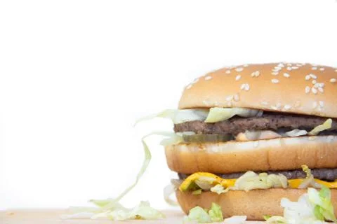 Burger on a white background. Cutlets bun sesame, cheese salad dressing. Impr Stock Photos