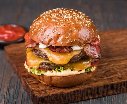 Burger on a wooden board Stock Photos