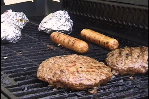 Burgers, Brats, and Chicken on Grill Stock Footage