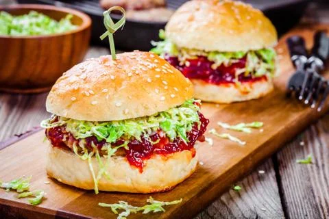 Burgers with a cutlet of turkey, cranberry sauce and salad Stock Photos