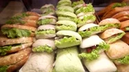 Burgers In Different Colors And With Different Fillings On Display At A Shop Stock Footage