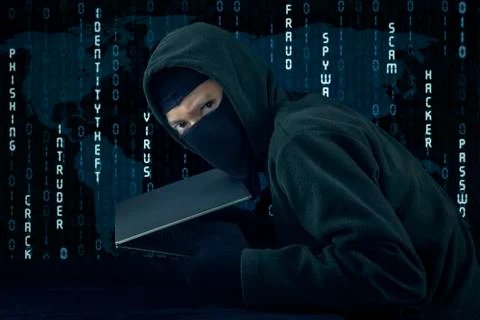 Burglar with binary code background stealing laptop 库存照片
