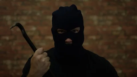 Burglar with crowbar steps off frame fully lit Video stock 91794221