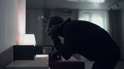 Burglar tries to find the combination code of a safe Stock Footage 138837990