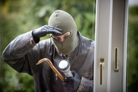 Burglar at a window Stock Photos