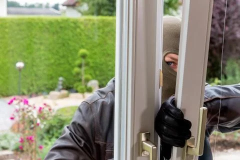 Burglar at a window Stock Photos