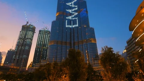 Burj Khalifa highest tower in world and illuminated buildings at night Dubai Stock Footage 125554959