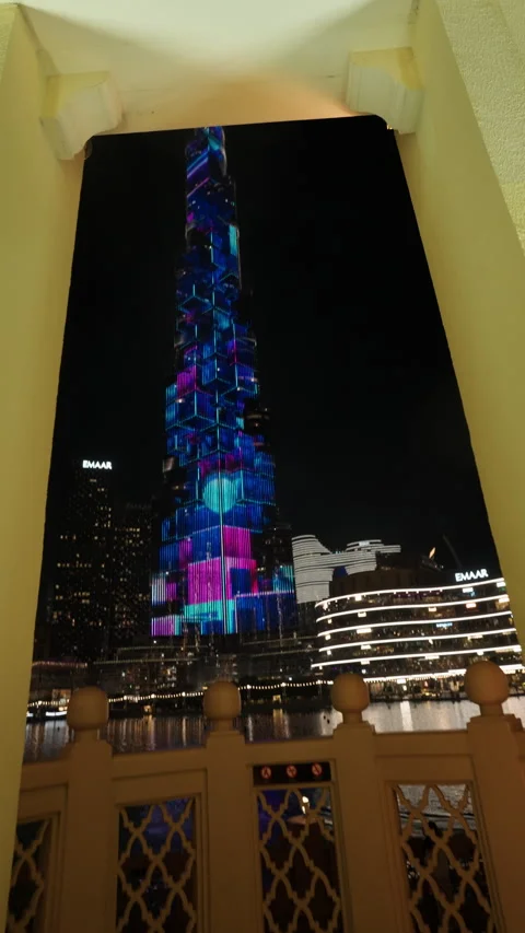 Burj Khalifa light display framed by arch with Emaar in Dubai UAE Stock Footage 344958055