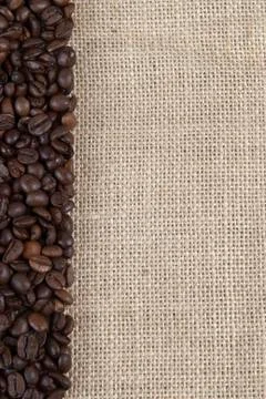 Burlap background with coffee beans. Stock Photos