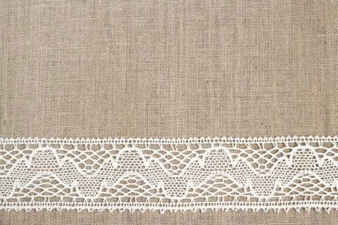 Burlap background with lace Stock Photos