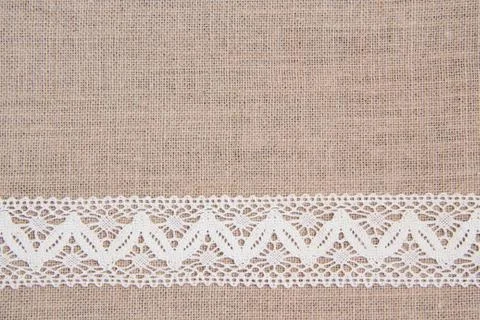 Burlap background with lace Stock Photos