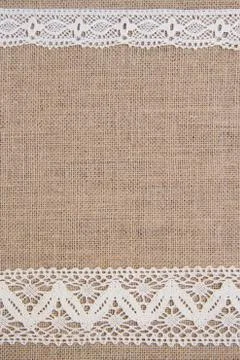 Burlap background with lace Stock Photos