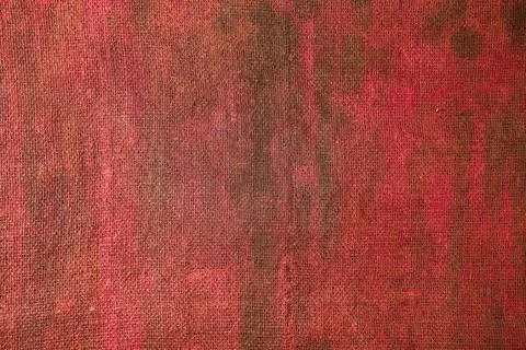 Burlap background painted with colored paint in crimson color Stock Photos