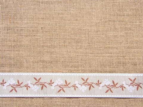 Burlap background with ribbon Stock Photos