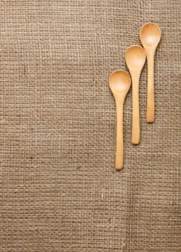 Burlap background with spoon Stock Photos