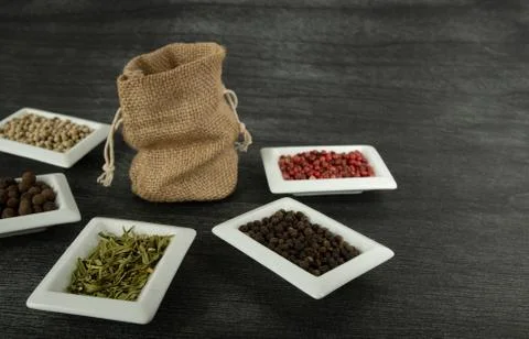 Burlap sack and natural spices on dark background. Jute Sack mock up and herb Stock Photos