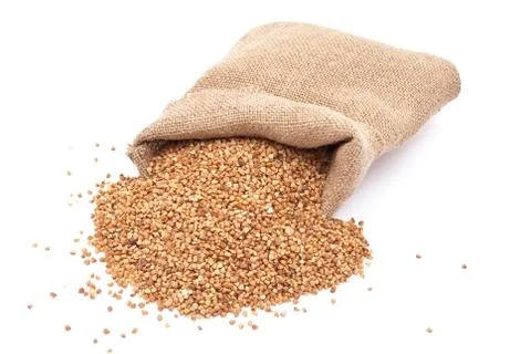 Burlap sack with buckwheat spilling Stock Photos