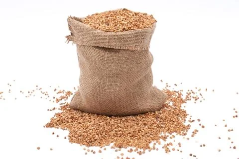 Burlap sack with buckwheat spilling Stock Photos