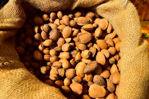 Burlap sack full of almonds Stock Photos