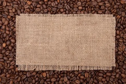 Burlap tag on the background of coffee Stock Photos