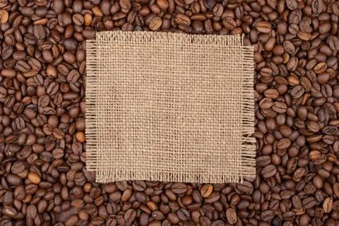 Burlap tag on the background of coffee Stock Photos