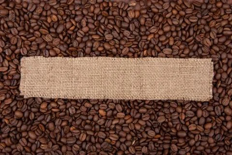 Burlap tag on the background of coffee Stock Photos