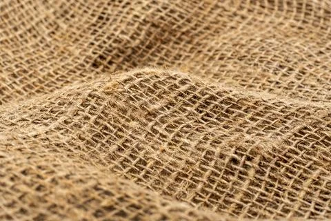 Burlap texture. Burlap fabric background with waves, folds and bruises Stock Photos