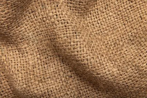 Burlap texture. A piece of torn burlap on a white background. Canvas. Packi.. Stockfoto's