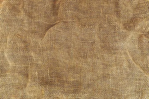 Burlap texture. A piece of torn burlap on a white background. Canvas. Packi.. Stock Photos