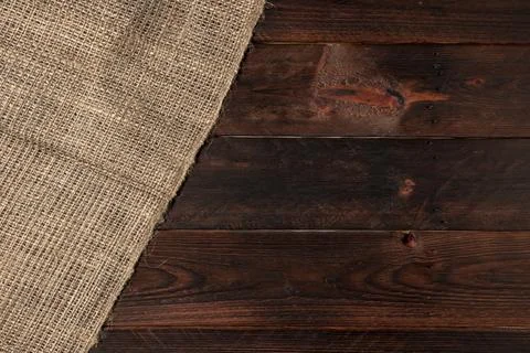 Burlap texture on wooden table background Stock Photos