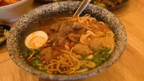 Burmese Beef Noodle Soup in Ceramic Bowl Stock-Footage 345471155
