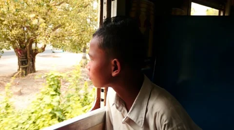 Burmese boy passenger looking into train window Video stock 62451633