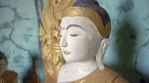 Burmese buddhist monk statue in buddhist cave temple in Mandalay. Panning shot Stock Footage 94928096