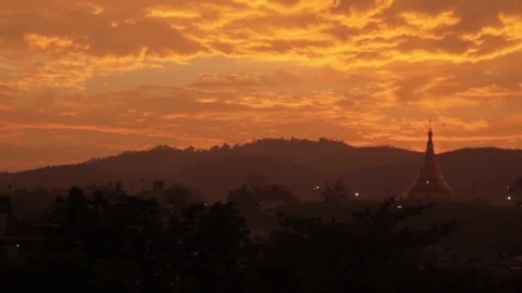 Burmese Pagoda in a Dramatic Sunset Stock Footage 77558746
