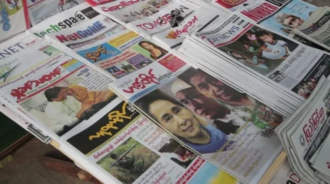 Burmese Range of Newspapers on Table - Aung San Suu Kyi (Yangon/Burma) Stock Footage 56632548