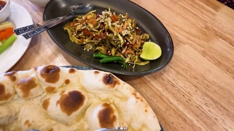 Burmese Tea Leaf Salad and Naan Bread on Restaurant Table Stock Footage 345099888