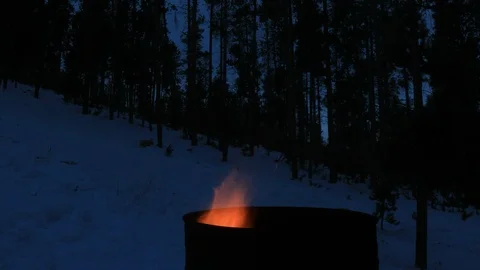 Burn barrel flames in winter landscape - 4k time lapse Stock Footage 101857684