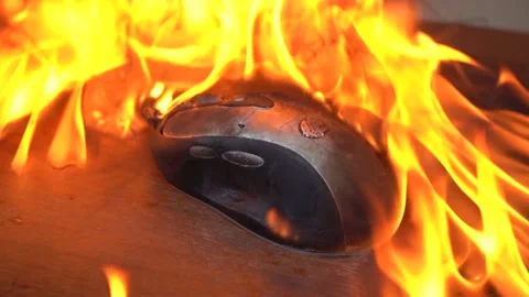 Burn the computer mouse. Concept, a computer mouse caught fire from overload and Stock Footage 142521772