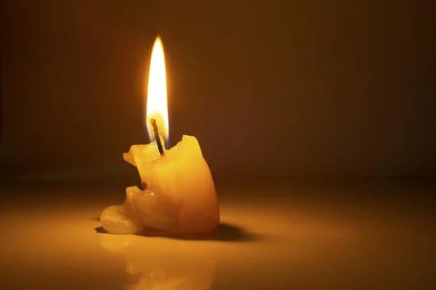 Burned candle on dark background Stock Photos