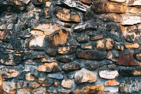 Burned Charred Stone Wall with Fire Damage Abstract Texture Macro Background Stock Photos